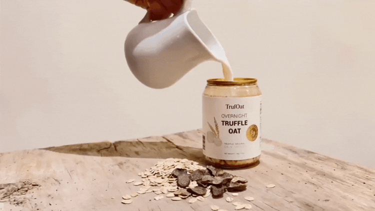 A can of TrufOat held in warm afternoon light